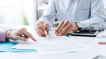 Business people negotiating a contract for insurance hard market for commercial property