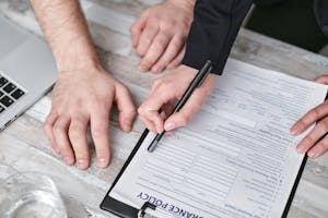 Local Agent Showing Insurance Policy form to Client