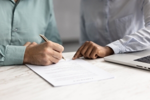 Retail Business Owner Signing Supply Chain Insurance Documents