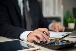 Retail Business Owner Checking Insurance Documents and Calculating Premium