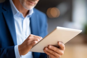 Retail Business Owner Reviewing Insurance Documents on Tablet