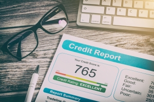 Strong Business Credit Score Document with Eyeglasses and Laptop