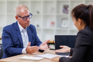 Female Retail Store Owner Discussing Insurance Plan with Experienced Agent