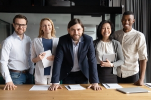 Smiling Business Owner with His Employees in Office
